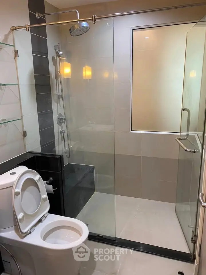 Modern bathroom with glass shower enclosure and sleek fixtures