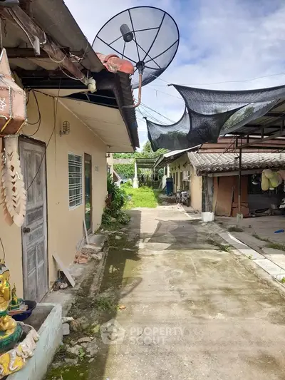 Charming rustic property with satellite dish and spacious outdoor area, perfect for renovation or investment.