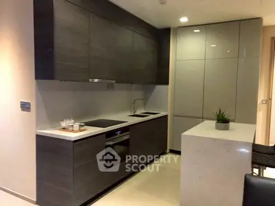 Modern kitchen with sleek cabinetry and integrated appliances in a contemporary apartment.