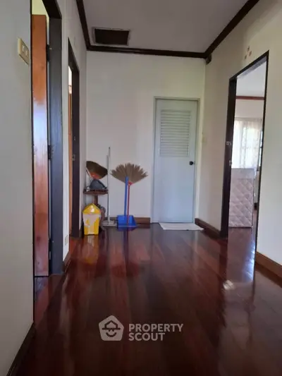 Spacious hallway with polished wooden floors and natural light