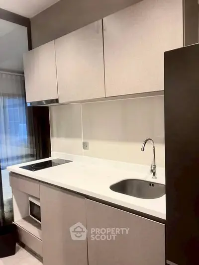 Modern kitchen with sleek cabinetry and built-in appliances in a stylish apartment.