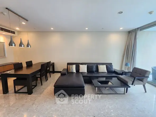 Spacious modern living room with sleek furniture and dining area