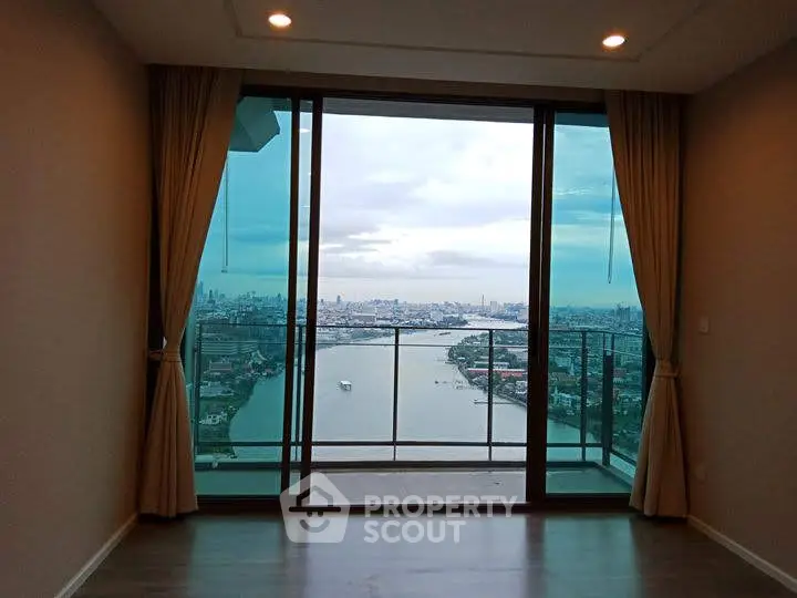 Stunning high-rise apartment with panoramic river view and floor-to-ceiling windows.