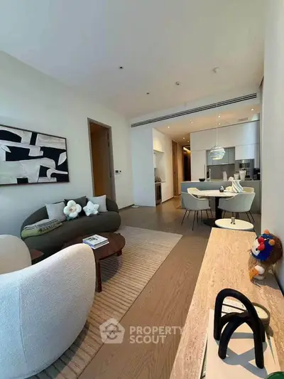 Modern open-plan living room with stylish furniture and kitchen in luxury apartment
