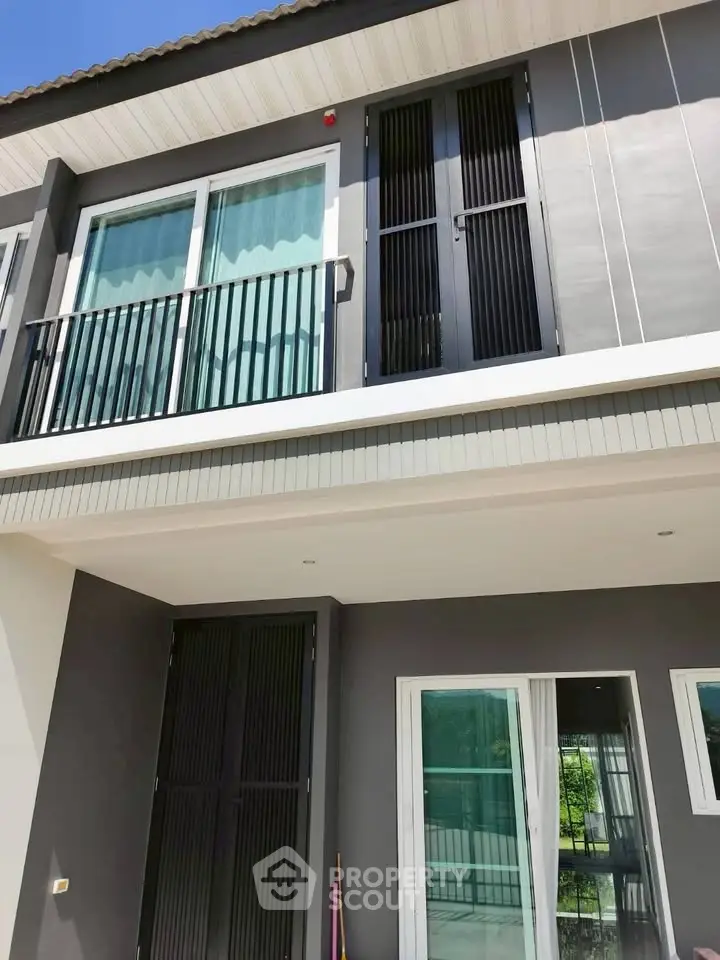 Modern two-story house exterior with sleek design and large windows