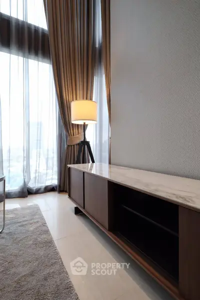 Elegant living room with floor-to-ceiling windows and modern decor