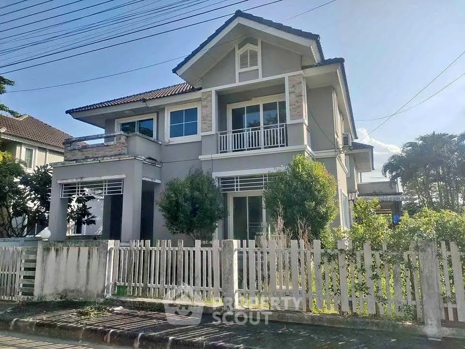 Charming two-story house with a fenced garden and balcony in a serene neighborhood.