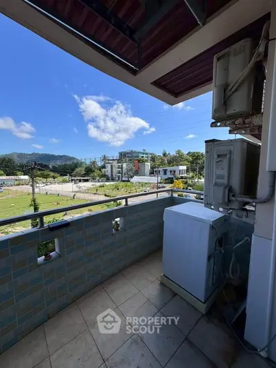 Charming balcony with scenic view and washing machine, perfect for relaxation and convenience.