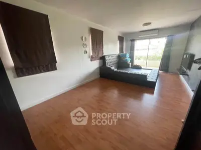 Spacious living room with modern decor and large windows for natural light.