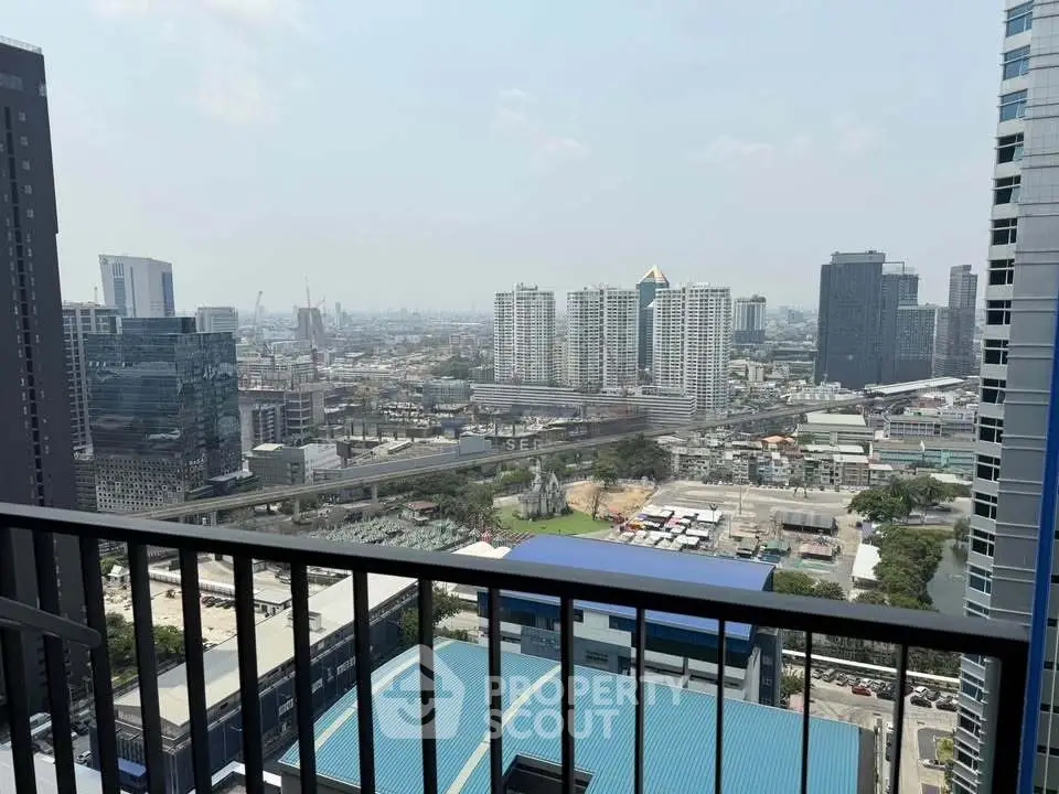 Stunning cityscape view from a high-rise balcony, showcasing urban skyline and modern architecture.