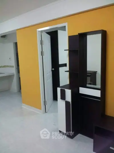 Modern interior with vibrant yellow accent wall and sleek furniture