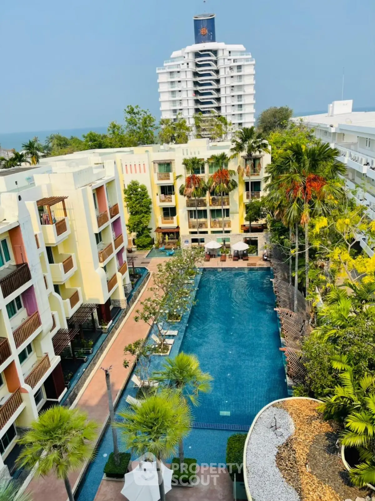 Luxurious condominium with stunning pool view and lush greenery