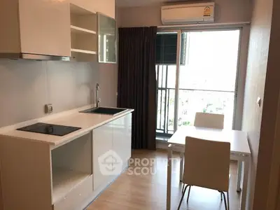 Modern kitchen with open layout and balcony view in stylish apartment