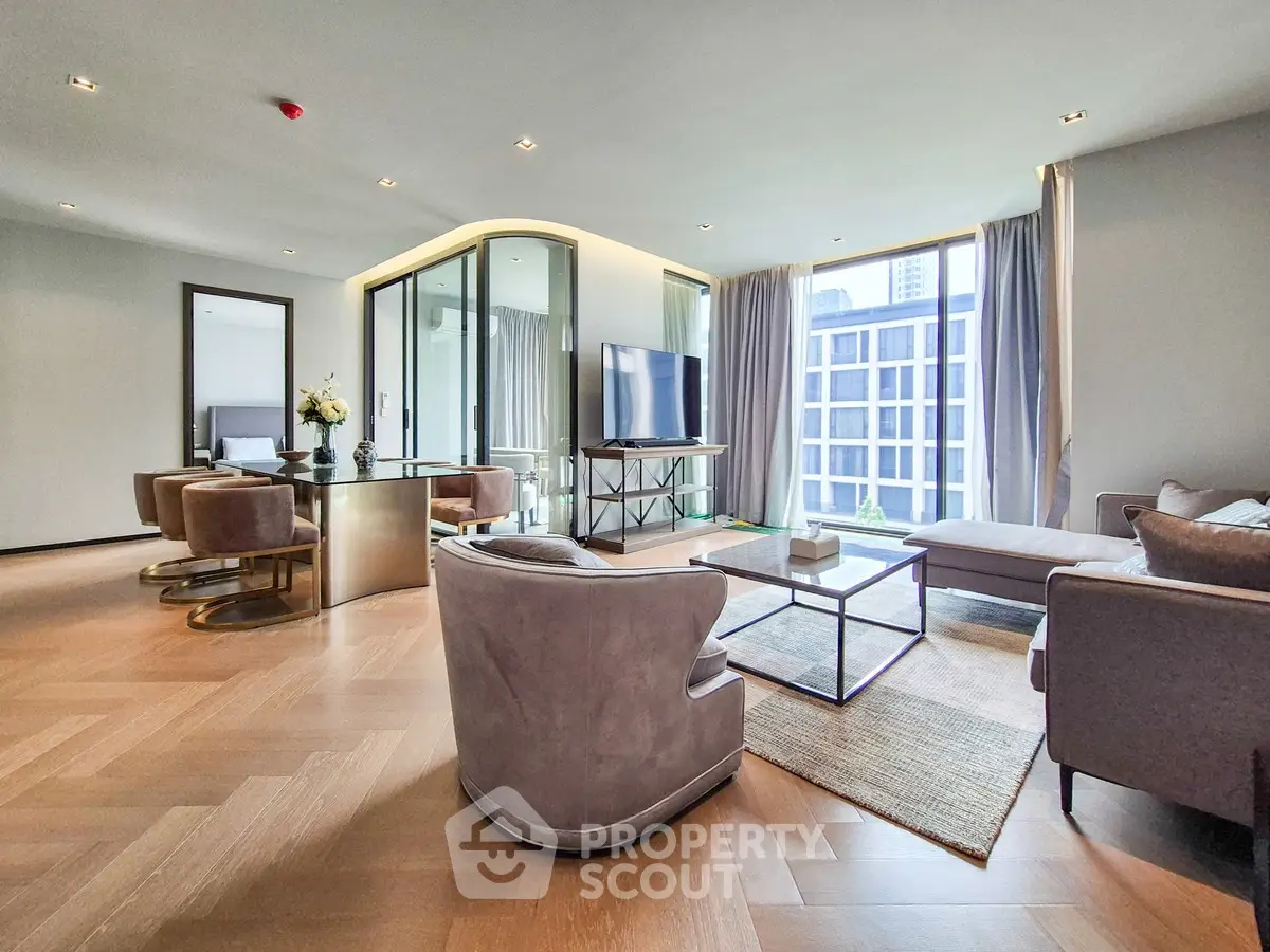 Luxurious modern living room with elegant furniture and large windows offering city views.