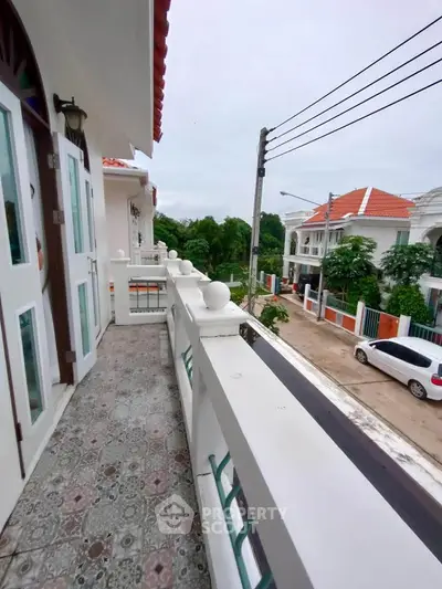 Charming balcony with tiled flooring and scenic neighborhood view