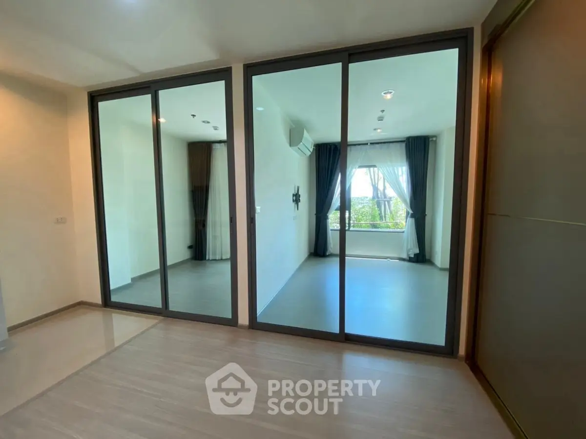 Spacious modern living room with large glass doors and natural light