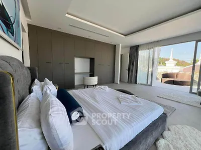Luxurious bedroom with modern design and large windows offering stunning views.