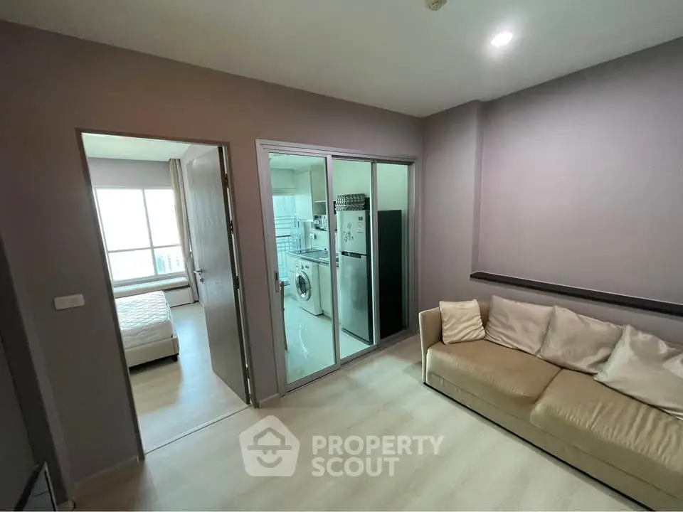 Modern apartment interior with cozy living room, bedroom, and kitchen featuring washing machine and fridge.