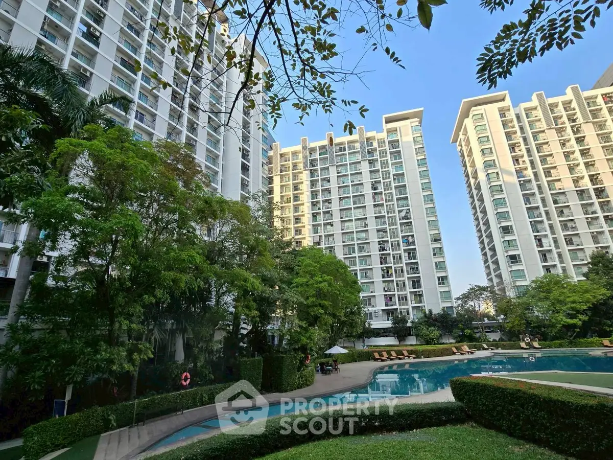 Luxurious residential complex with pool and lush greenery, offering modern urban living.