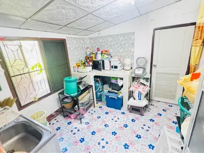 Charming kitchen with colorful tiled floor and ample storage space, perfect for culinary enthusiasts.