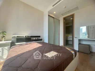 Modern bedroom with large window and city view, featuring sleek furniture and ample natural light.