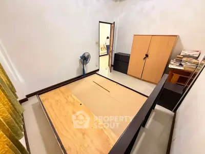 Spacious bedroom with wooden wardrobe and fan, ready for customization.