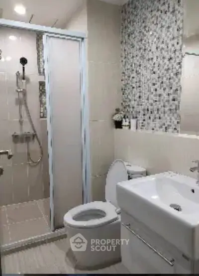 Modern bathroom with sleek shower and stylish mosaic tiles