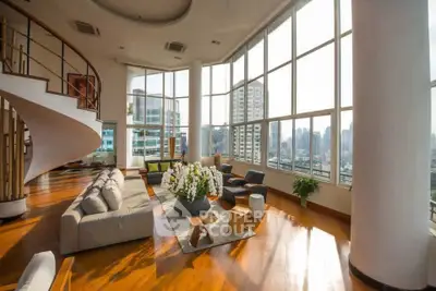 Luxurious penthouse living room with panoramic city views and elegant spiral staircase.