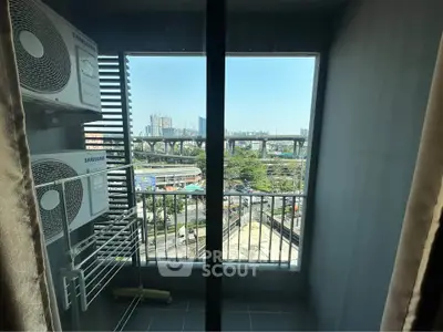 Modern apartment balcony with city view and air conditioning units, perfect for urban living.