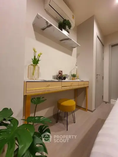 Stylish study nook with modern desk, air conditioning, and decorative plants in a cozy apartment.