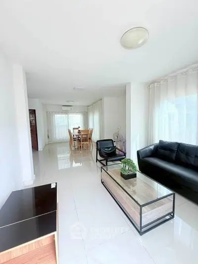 Spacious modern living room with sleek furniture and abundant natural light