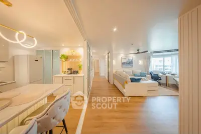 Spacious open-plan living room and kitchen with modern decor and natural light