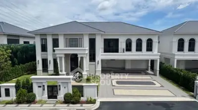 Luxurious modern mansion with grand entrance and spacious driveway in upscale neighborhood.