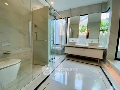 Luxurious modern bathroom with glass shower and double vanity