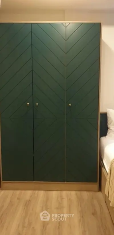 Stylish bedroom with modern wardrobe and cozy bed setup