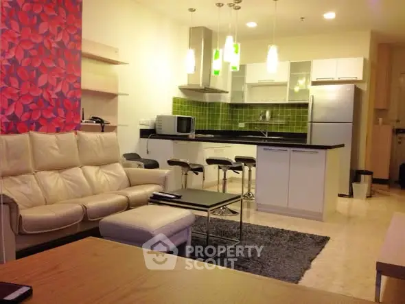 Modern open-layout living room with stylish kitchen and cozy seating area