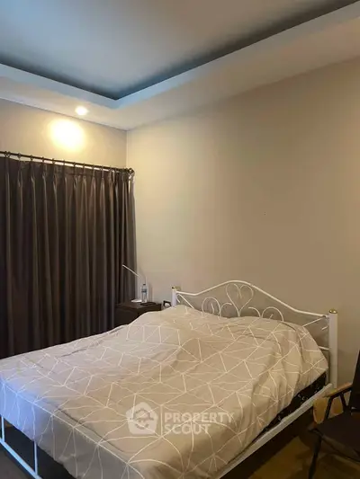 Cozy bedroom with elegant bed and soft lighting, perfect for relaxation.