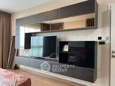 Modern living room with sleek wall-mounted entertainment unit and large TV