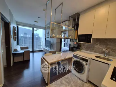 Modern open-plan kitchen and living room with stylish decor and balcony view.