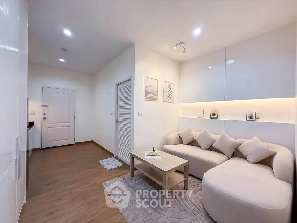 Modern living room with cozy sofa and stylish decor in a contemporary apartment.