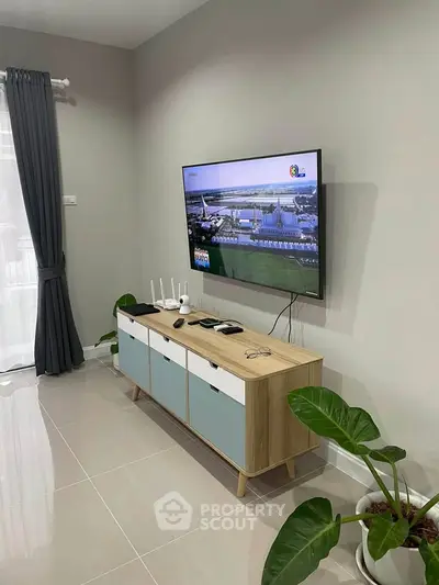 Modern living room with sleek TV setup and stylish cabinet