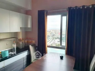 Modern kitchen with stunning city view, featuring sleek cabinets and dining area.