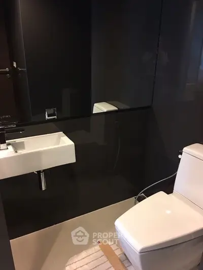 Modern bathroom with sleek black tiles and contemporary fixtures