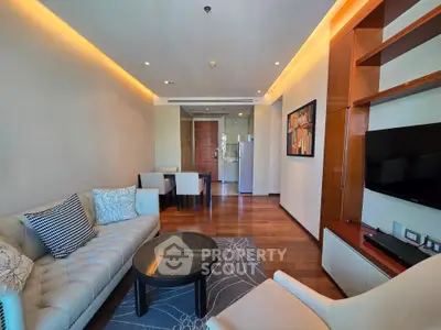 Modern living room with elegant furniture and open layout, featuring a cozy seating area and stylish decor.