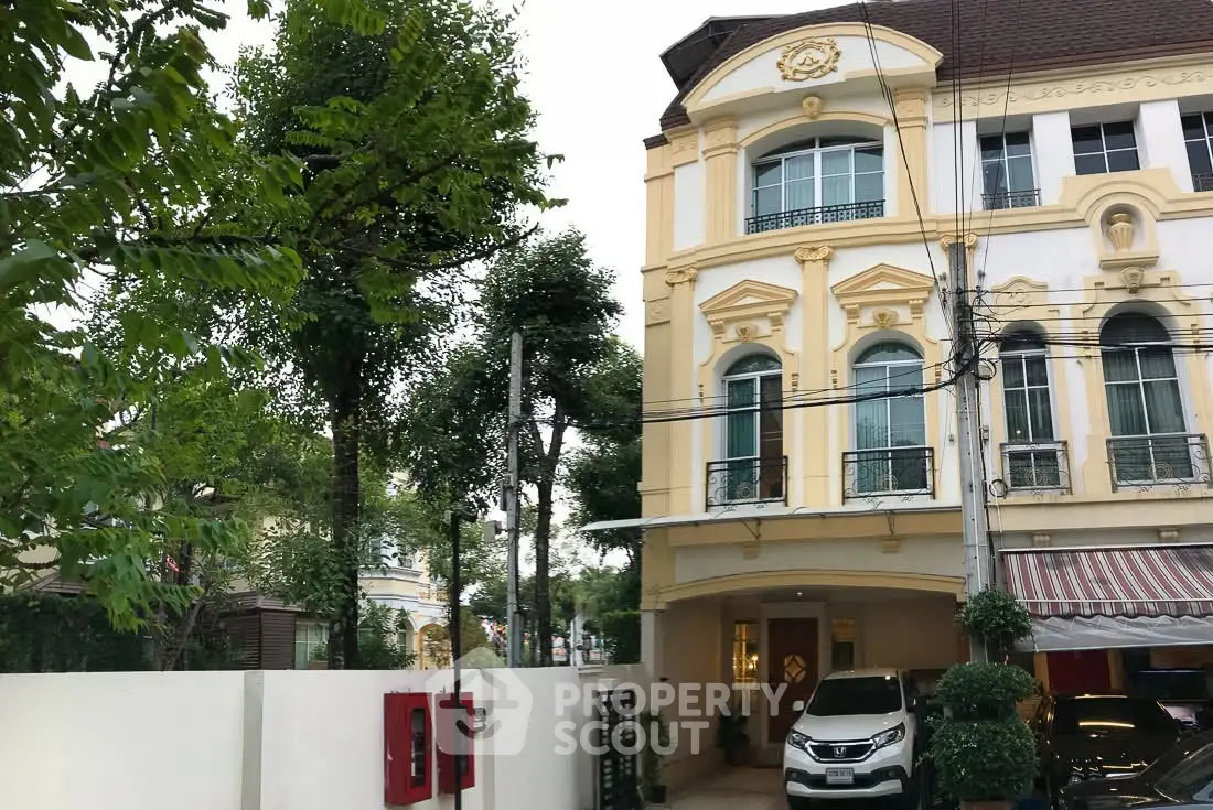 Elegant three-story townhouse with classic architecture and lush greenery in a serene neighborhood.