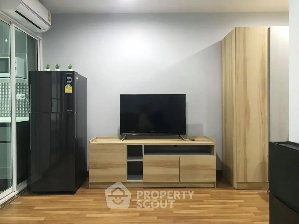 Modern living room with sleek TV stand and wooden flooring
