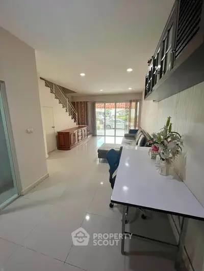 Spacious living room with modern decor and large windows offering natural light.