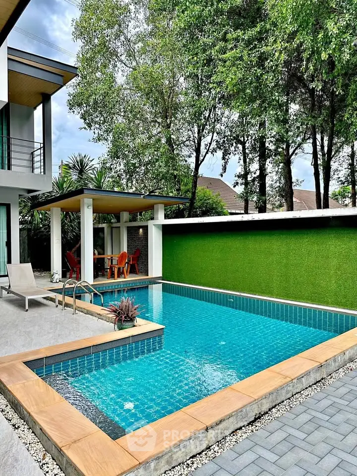 Luxurious modern home with private pool and lush greenery, perfect for relaxation and entertainment.