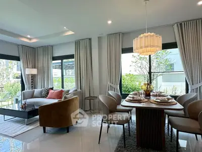 Elegant living and dining area with modern furniture and large windows