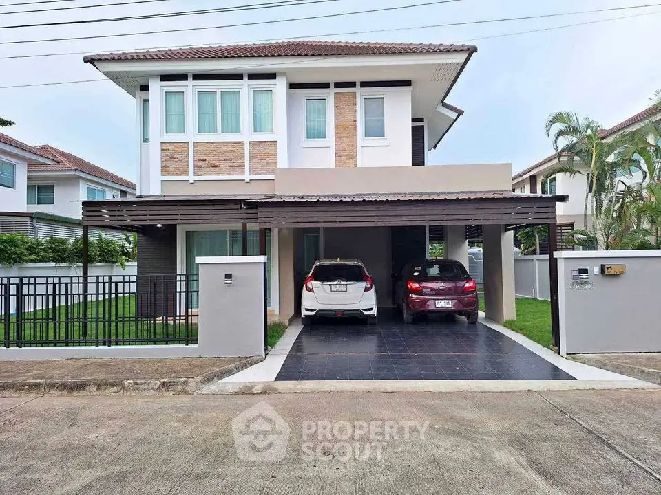 Modern two-story house with carport and landscaped front yard in suburban neighborhood.
